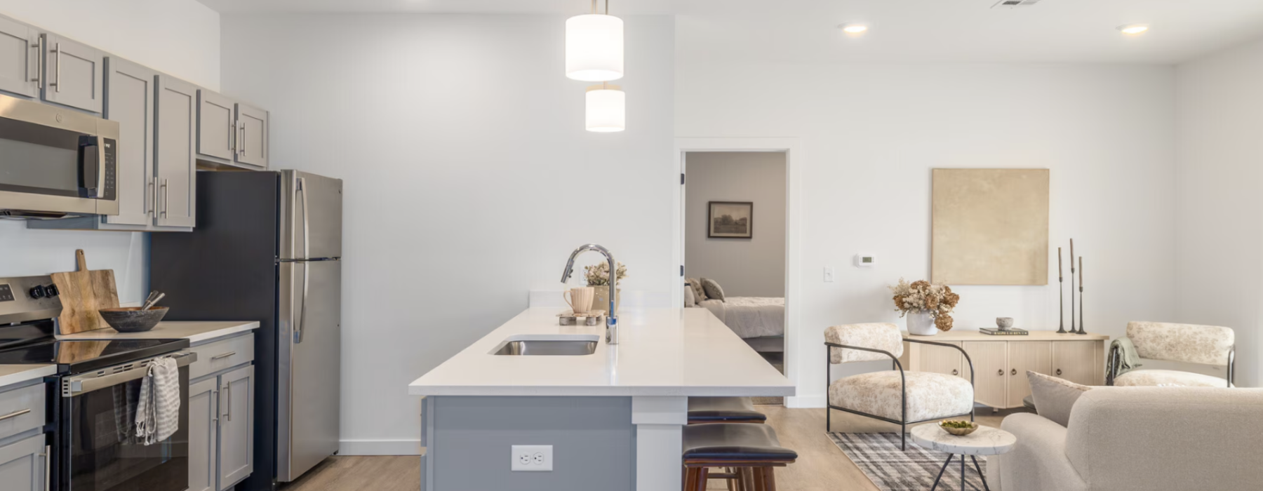 Kitchen and  living room with a couch, coffee table and chairs